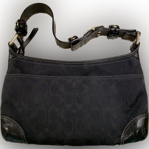 Coach Black Signature Canvas Medium Bleeker Handbag with Grommet Detail.